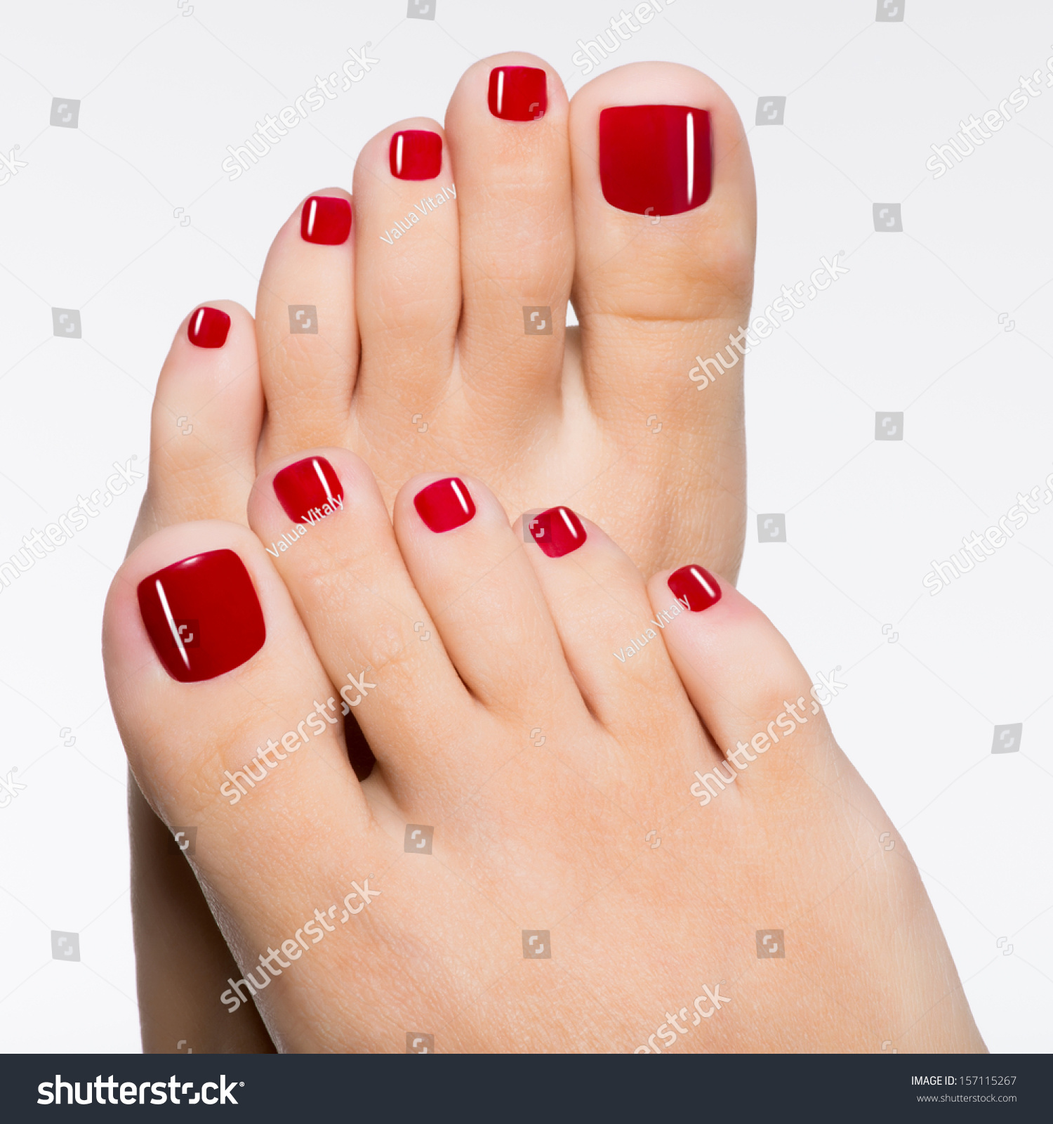 stock-photo-closeup-photo-of-a-beautiful-female-feet-with-red-pedicure-isolated-on-white-157115267